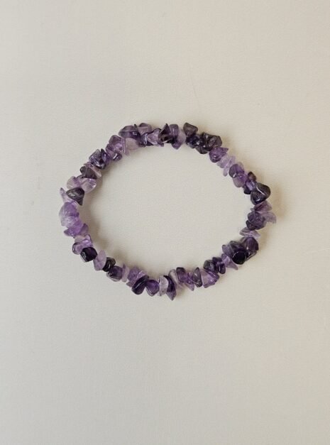 amethyst-bracelet-01 Amethyst crystal bracelet with polished purple chips on a cream background