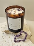 Amethyst crystal bracelet beside the Luna candle on travertine, Amethyst chips set in the wax