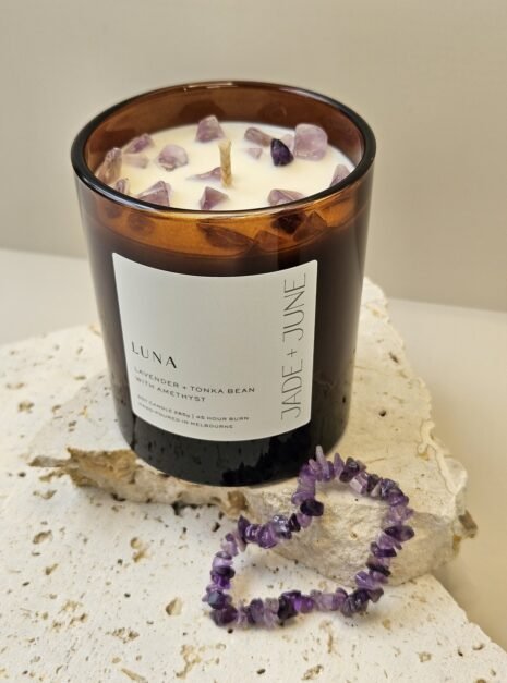 amethyst-bracelet-02 Amethyst crystal bracelet beside the Luna candle on travertine, Amethyst chips set in the wax