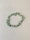 Green Aventurine crystal bracelet with polished green chips on a cream background