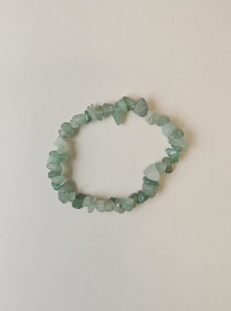Green Aventurine crystal bracelet with polished green chips on a cream background