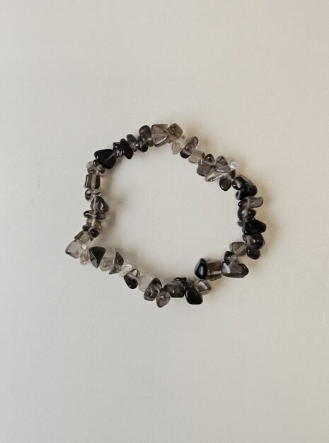 smoky-quartz-bracelet-01 Smoky Quartz crystal bracelet with polished grey chips on a cream background