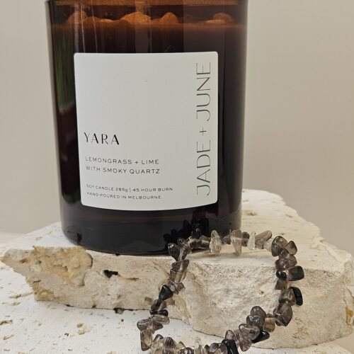 Smoky Quartz crystal bracelet on travertine beside the Yara candle