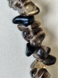 Close view of the polished Smoky Quartz chips on the bracelet