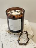 Tiger's Eye crystal bracelet beside the Maia candle on travertine, Tiger's Eye chips set in the wax