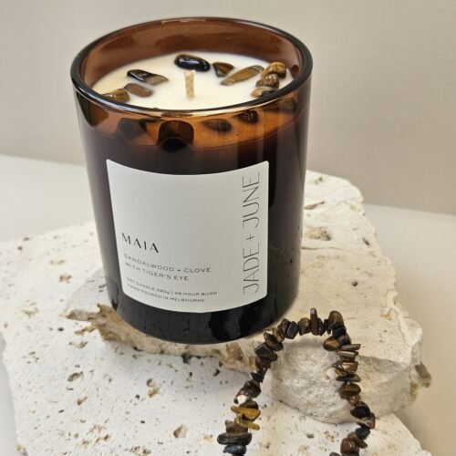Tiger's Eye crystal bracelet beside the Maia candle on travertine, Tiger's Eye chips set in the wax