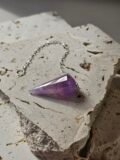 Faceted Amethyst pendulum on a silver chain, full piece in frame