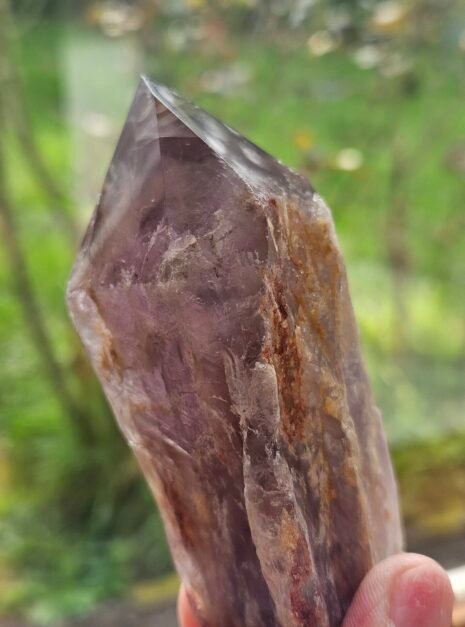 Bahia Amethyst 9 Close view of a Bahia Amethyst point held in the fingers outdoors
