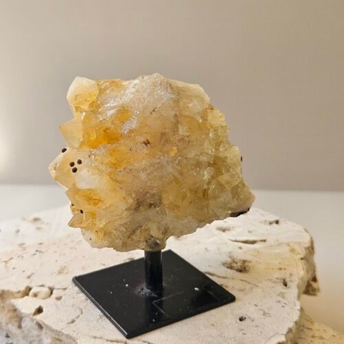Citrine cluster raised on a stand, front facing
