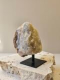 Citrine cluster on its stand, seen in side profile