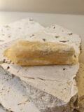 Bahia Citrine point on a stone surface, seen from a raised angle