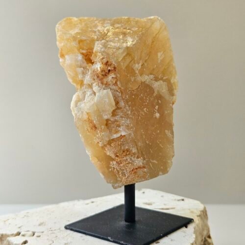 Rough Citrine on a black metal stand, front facing