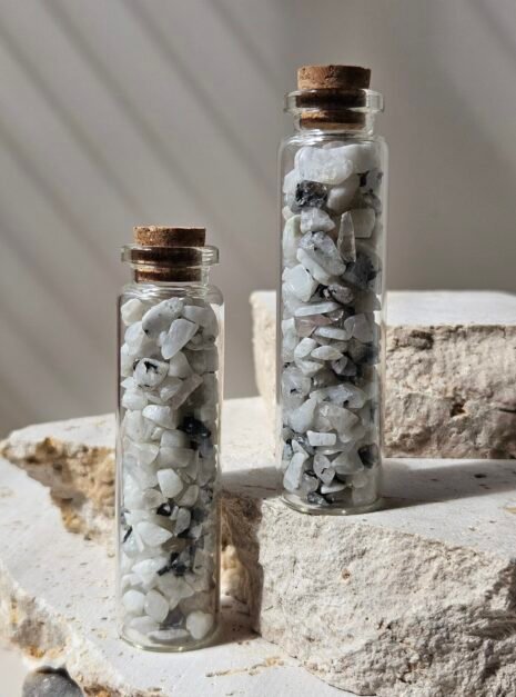 Moonstone Vials 3 Two vials of Rainbow Moonstone chips standing close together, showing the chips through the glass