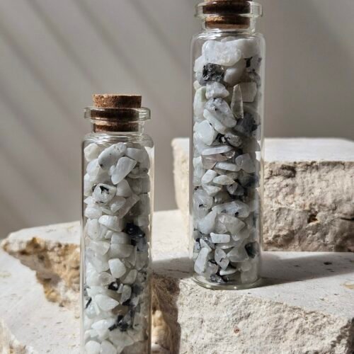 Moonstone Vials 3 Two vials of Rainbow Moonstone chips standing close together, showing the chips through the glass