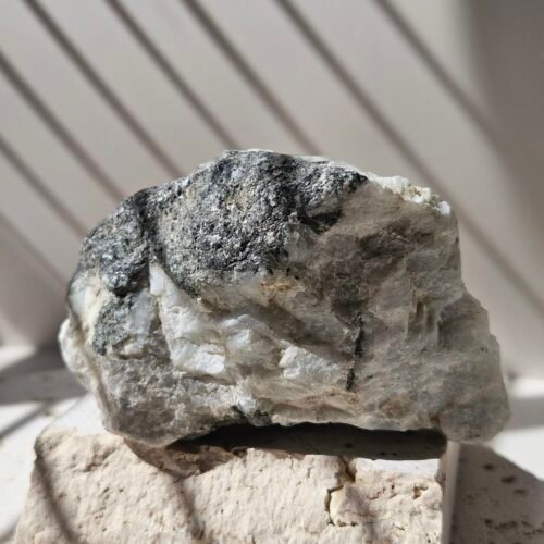 Rainbow Moonstone freeform standing upright, front on, polished soft white stone