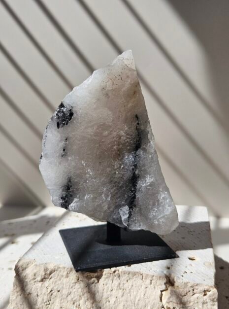 Rough Moonstone 3 Rough Rainbow Moonstone on its stand, side profile showing a thin sail shaped face